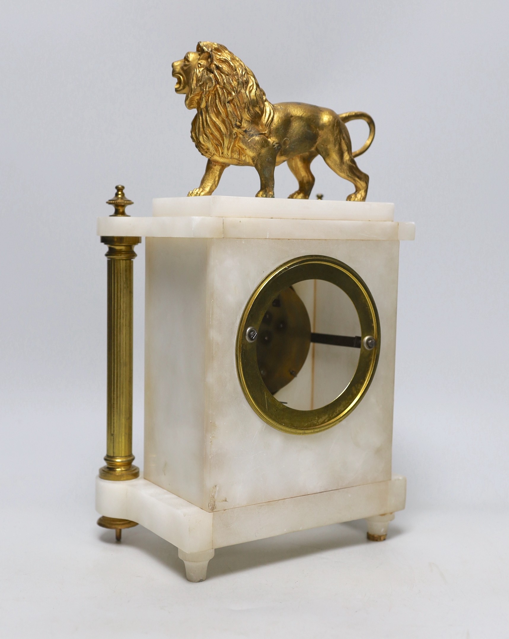 A French alabaster and gilt metal lion and ceramic mounted mantel clock, 34cm high